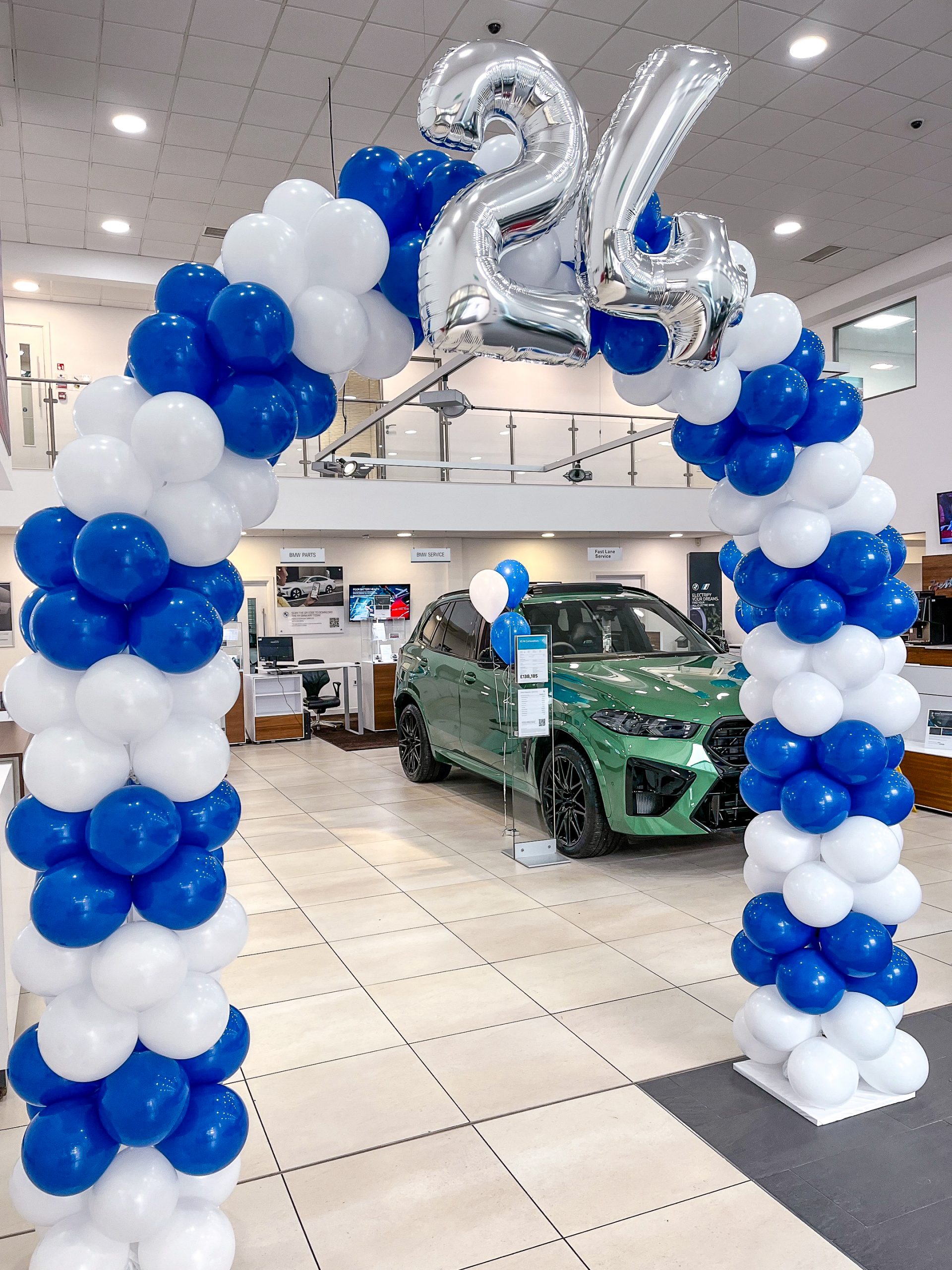 BMW Blue and white balloon arch with silver foil lettering